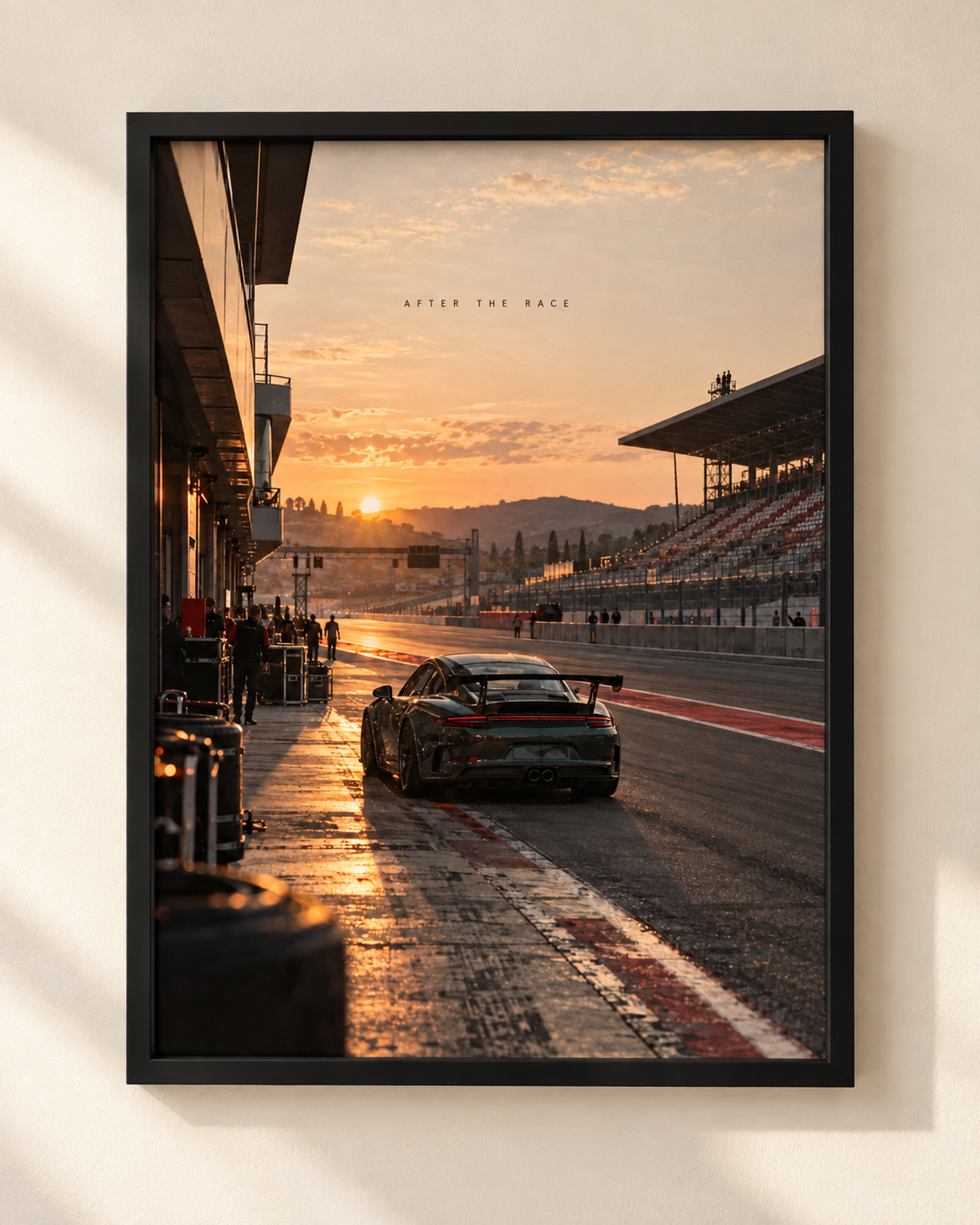 After The Race framed automotive poster by NEX, showing a sports car on a pit lane at sunset
